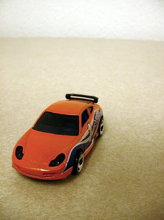 a toy car sitting on the ground in a room