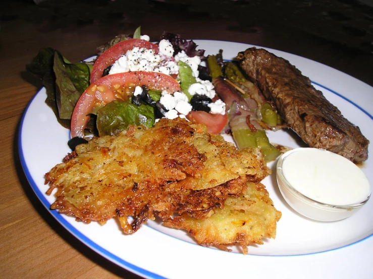 a close - up po of a plate of food containing fish, tomatoes, asparagus and salad