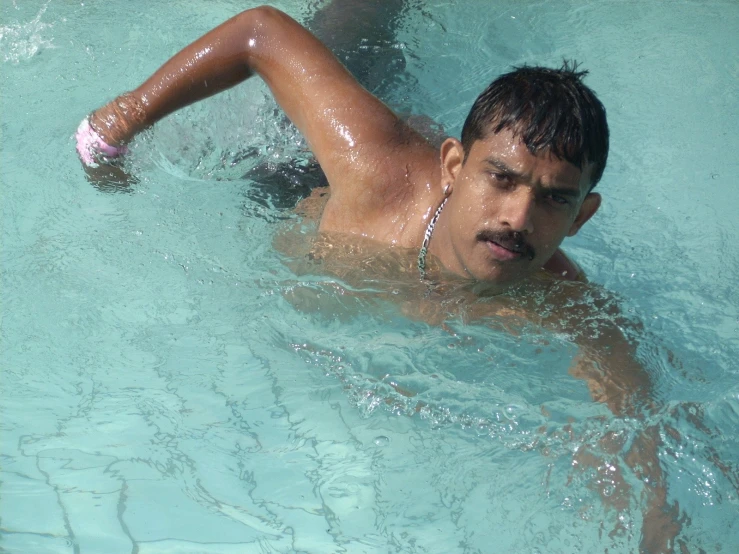 a man in a blue swimming suit swimming