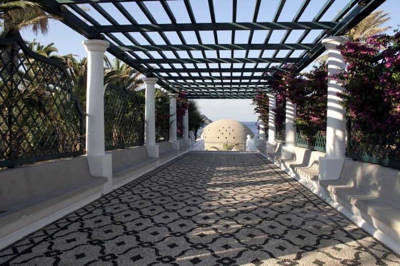 a walkway leads to a pavilion with white pillars