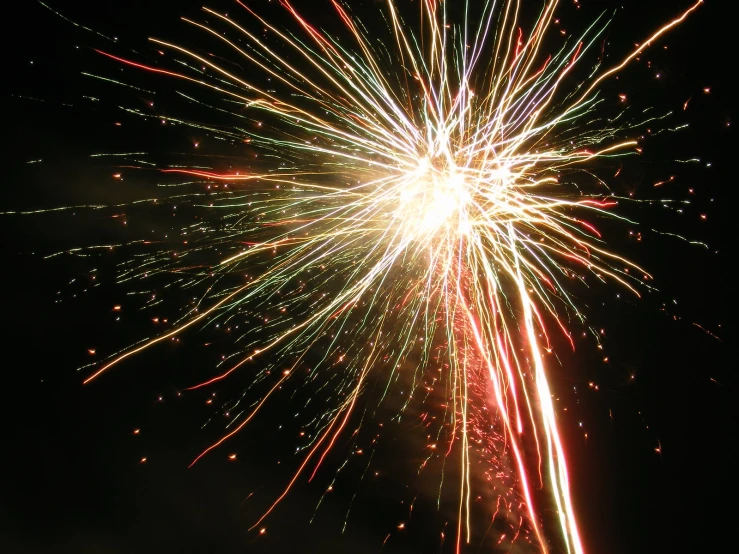 a fireworks with red, green and white colors