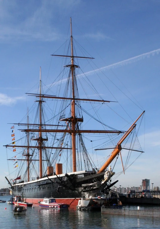 an old sailing ship is docked at the dock