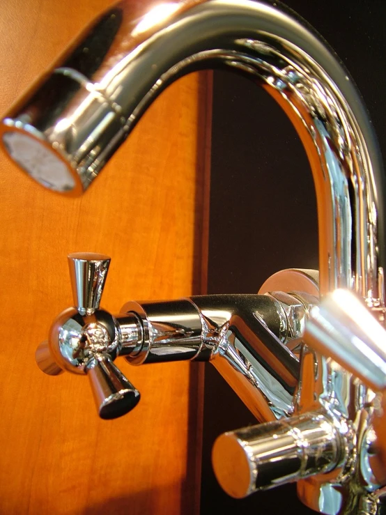 a faucet with chrome handle and spout on the side
