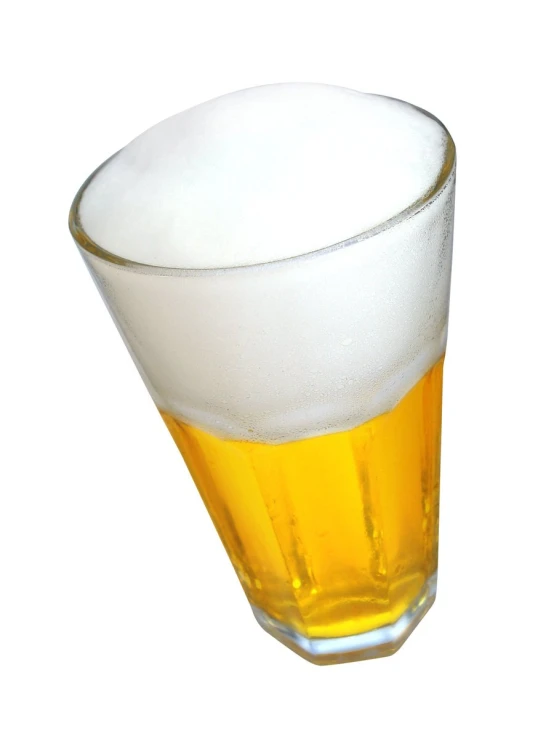 a glass is full of a light yellow beverage