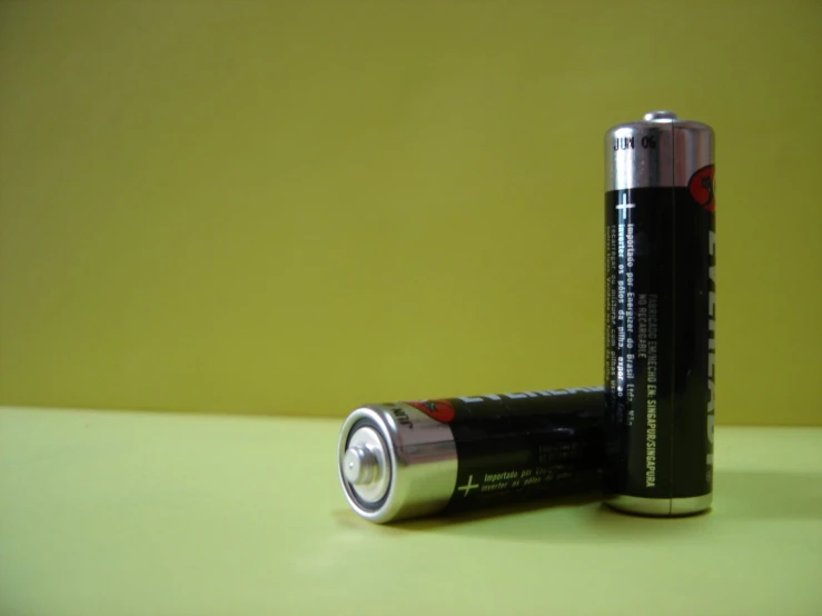 two batteries side by side, the one with an electronic plug