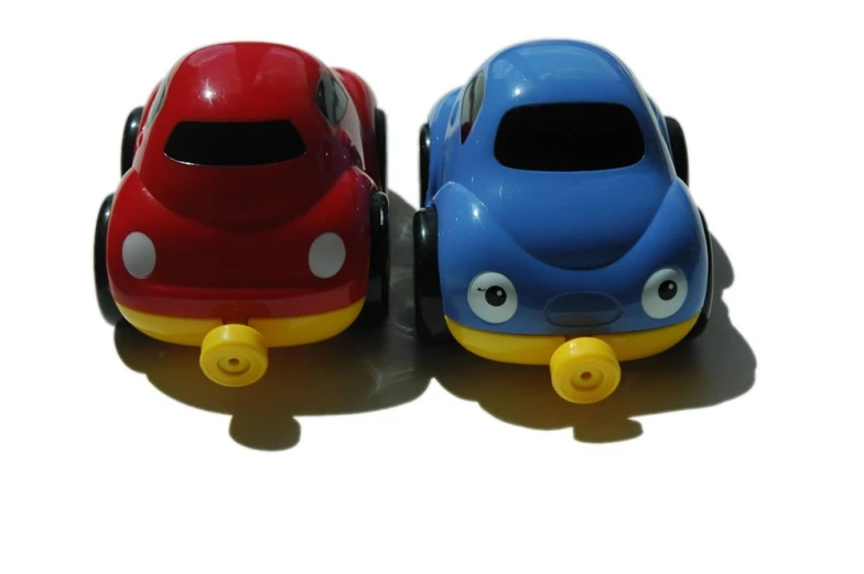 two cars with eyes sitting on the ground