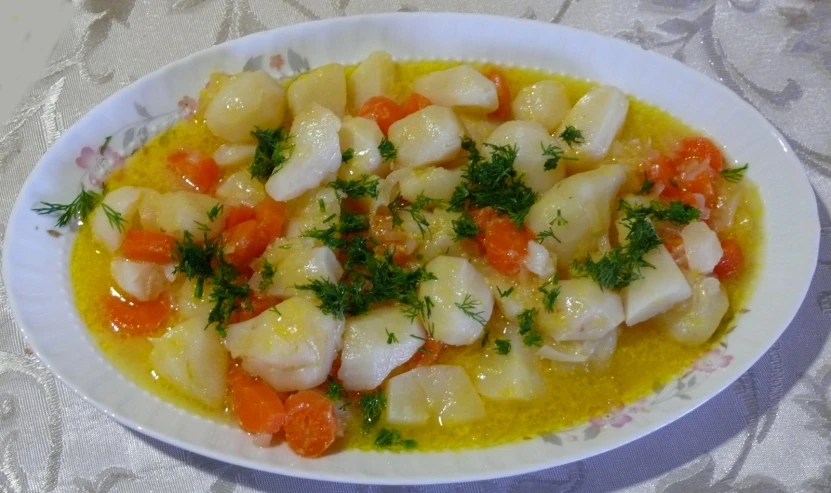 a small dish of food with carrots and shrimp