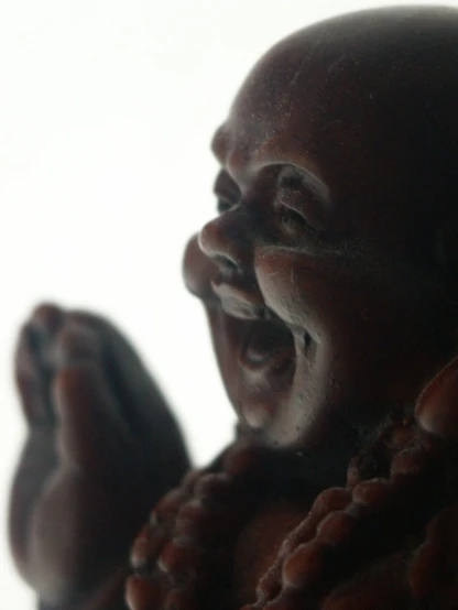 a figurine smiling while standing next to a window