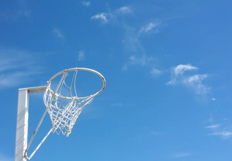 a basketball goal with a blue sky in the background