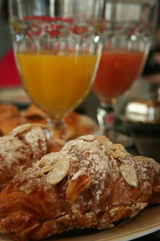 pastry items displayed next to cups and juice