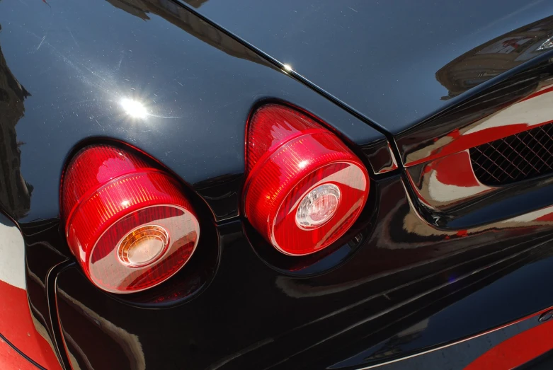 the rear lights on the car reflect red and white