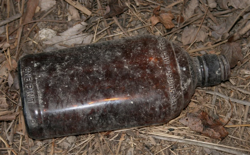 there is an empty metal bottle left on the ground