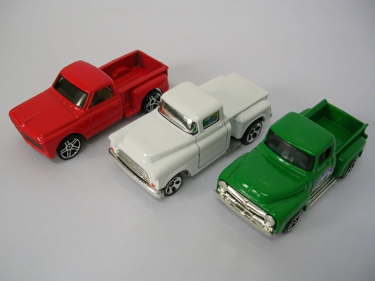 three models of a pickup truck and a pickup truck