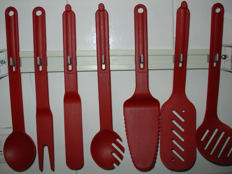 several different sized spatulas on a hooks