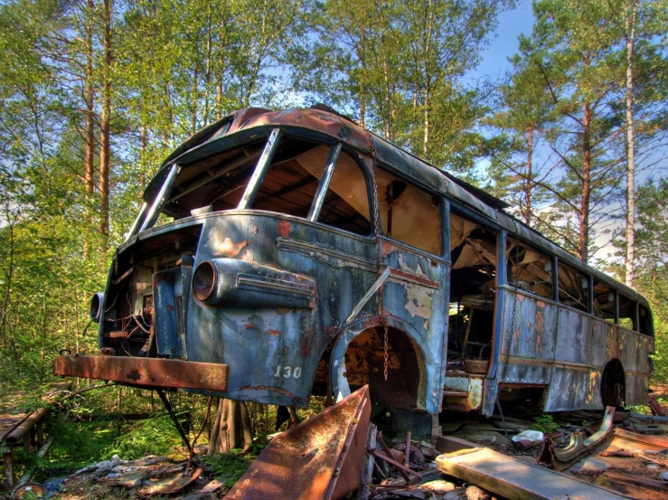 an old bus that has been sitting in the woods