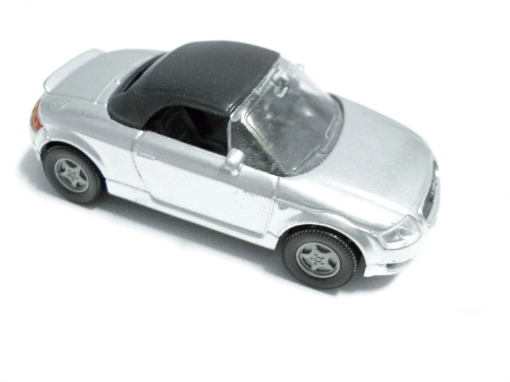 a small toy car on a white surface