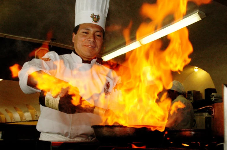 there is a chef that has some fire in the pot