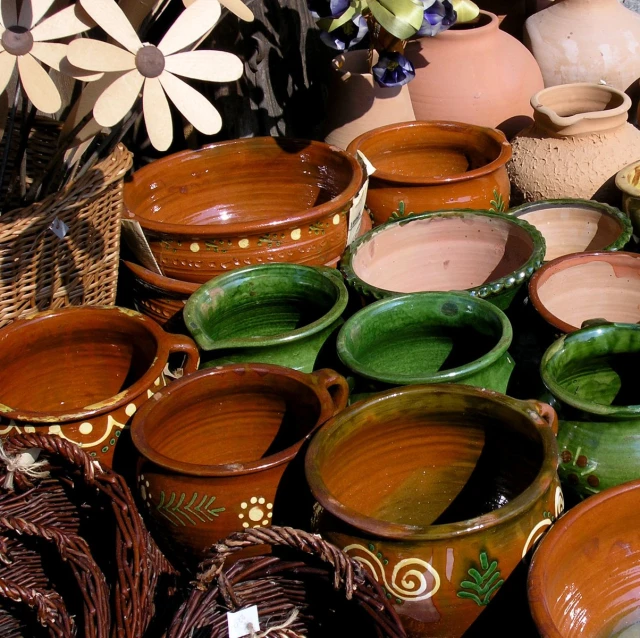 a pile of green and brown planters sitting on top of a wooden table