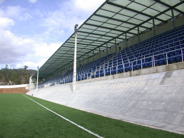 a large soccer field with blue and white stands