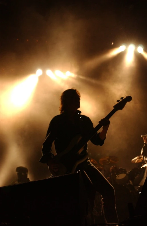 a guitarist with his guitar playing on stage