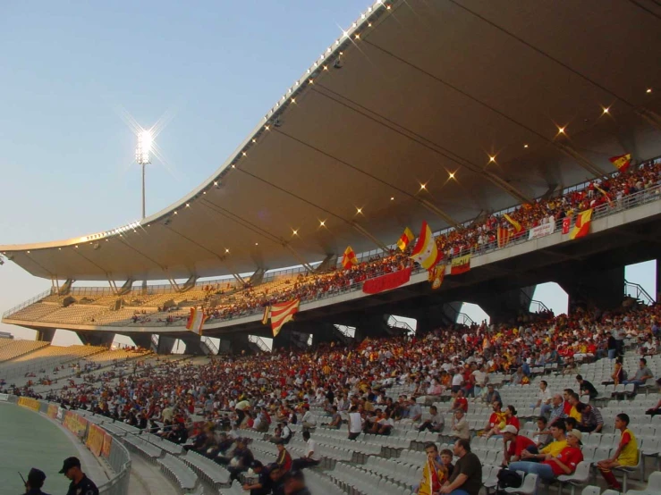 people are sitting in empty seats at a stadium