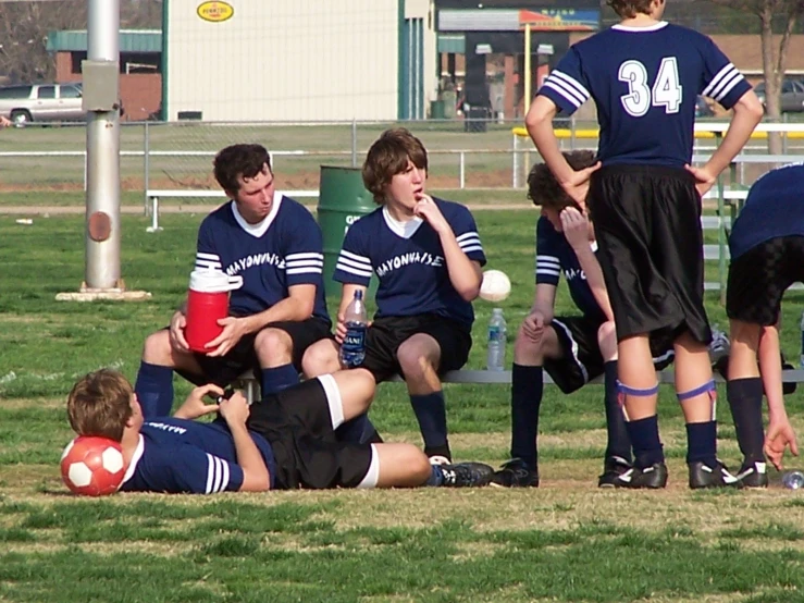 a group of young men sitting next to each other