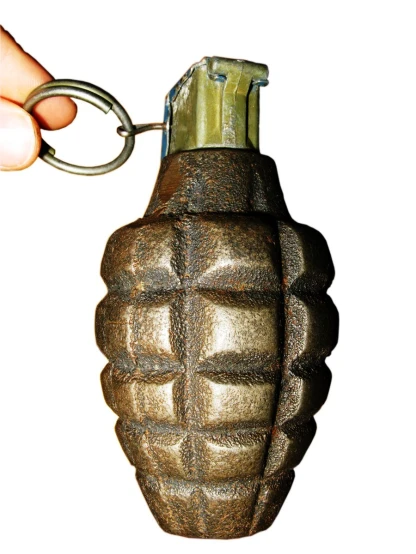 a hand holding a bronze colored glass bottle with a key chain attached