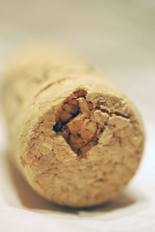 the cork of a partially peeled bottle wine