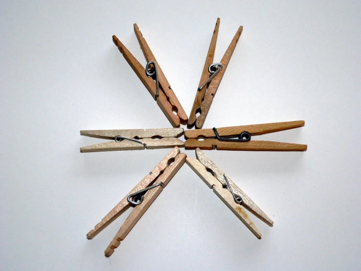 a snowflake made of wooden clothes pins