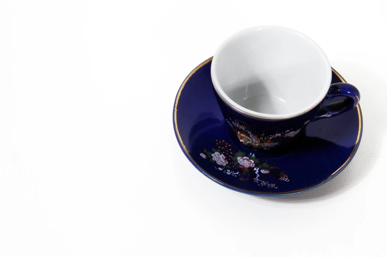 a porcelain cup sitting on top of a saucer