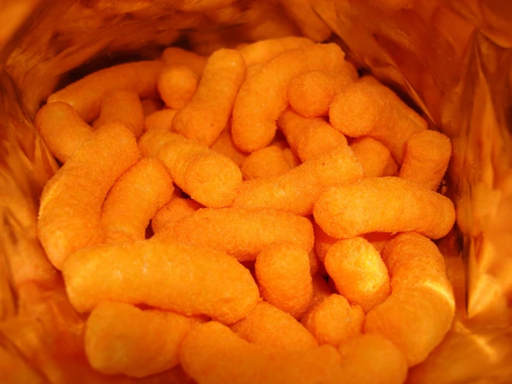 a bag full of cheese balls sitting on a table