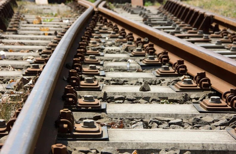 some very old rusty train tracks outside by itself