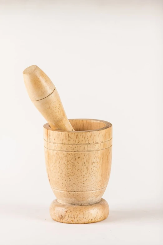 an old wooden mortar bowl and a wooden spoon