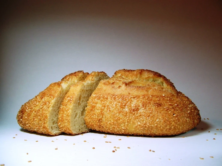 bread loaf cut into slices on top of white surface