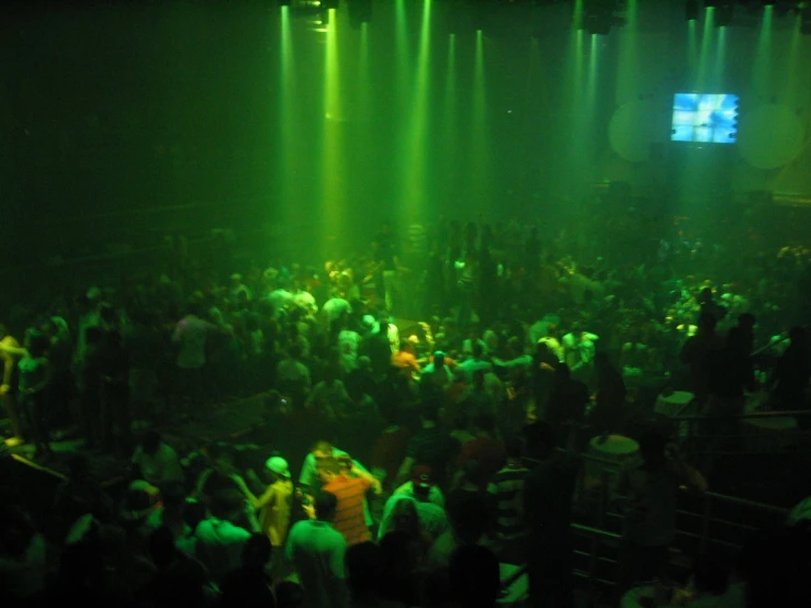 the crowd at a nightclub watches the music