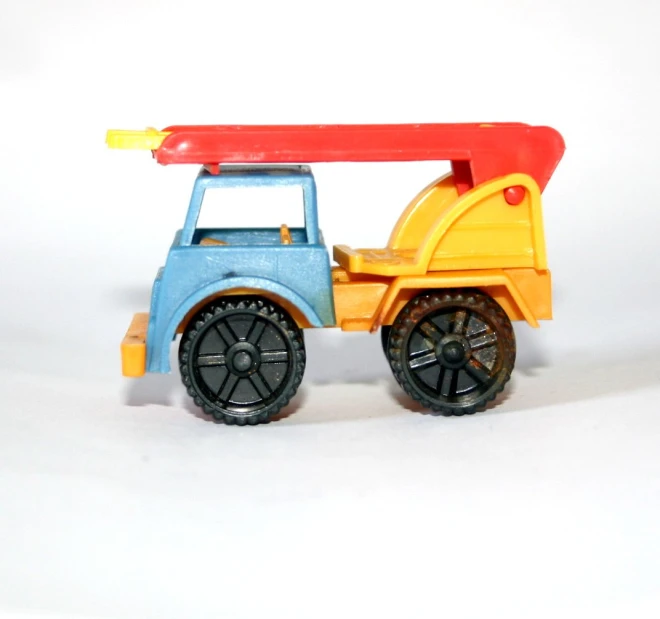 an orange and blue toy tractor is in the white background