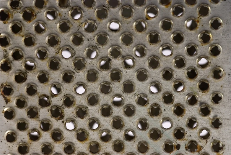 some holes that have been punched in to a metal surface