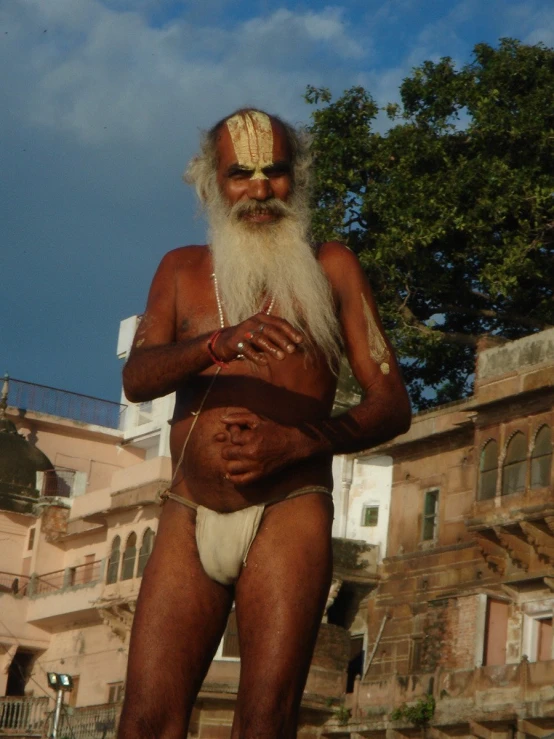 a man is dressed in a costume standing outdoors