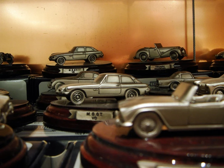 a room filled with miniature cars, and there is a shelf full of them