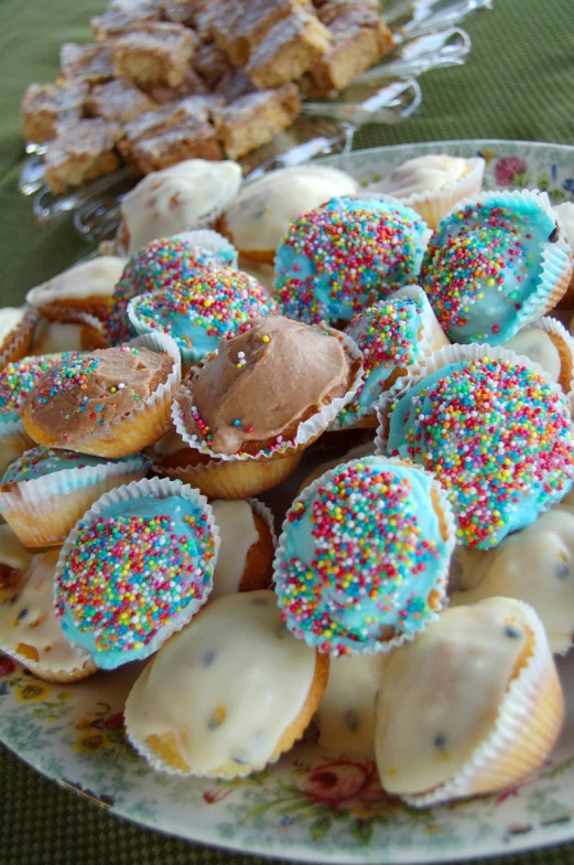 cupcakes are piled in rows on a plate