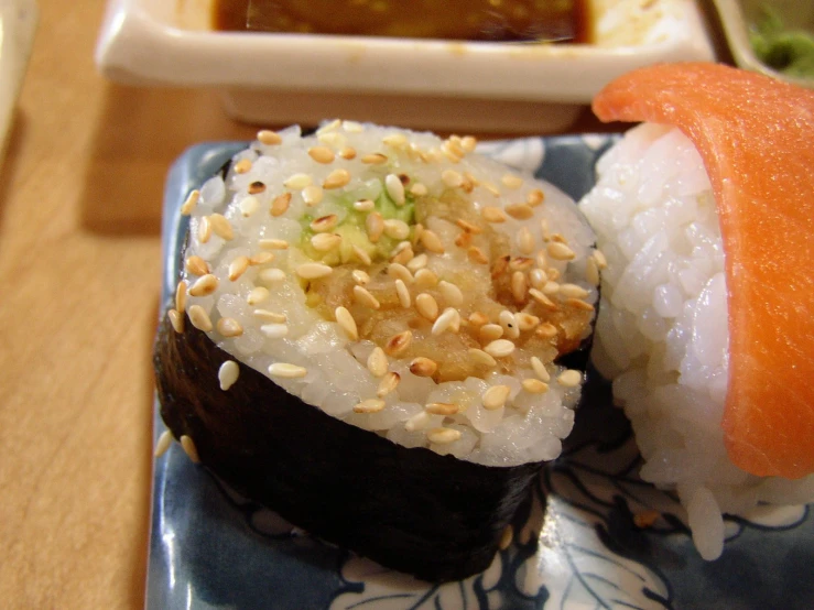 a sushi dish on a blue plate with various toppings