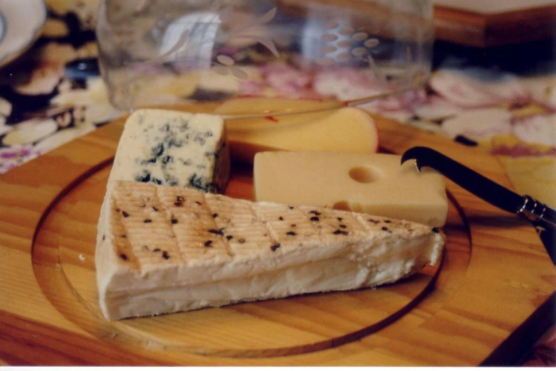 cheeses and vegetables are arranged on a platter