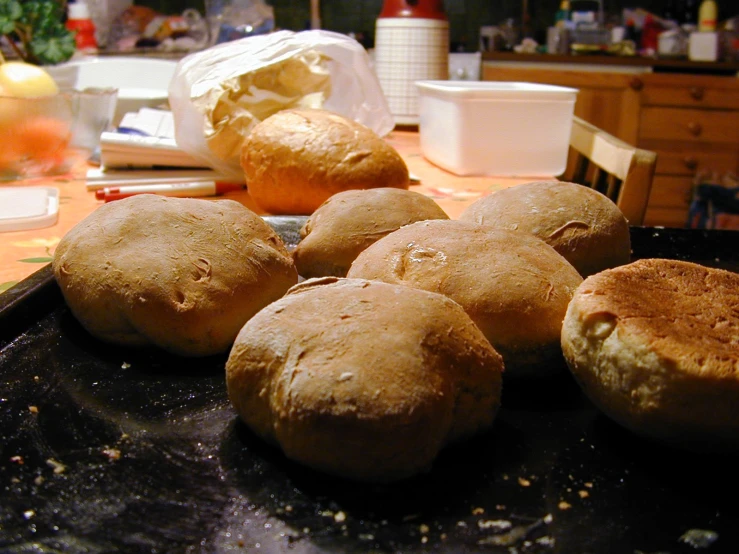 breads sitting in an ironing pan on a table