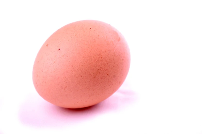 a close up of an egg on a white surface