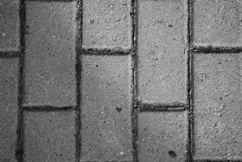 a cobble stone street with one way signs