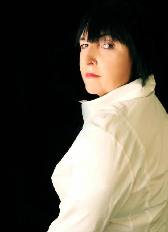 a woman with black hair looking up and to the side