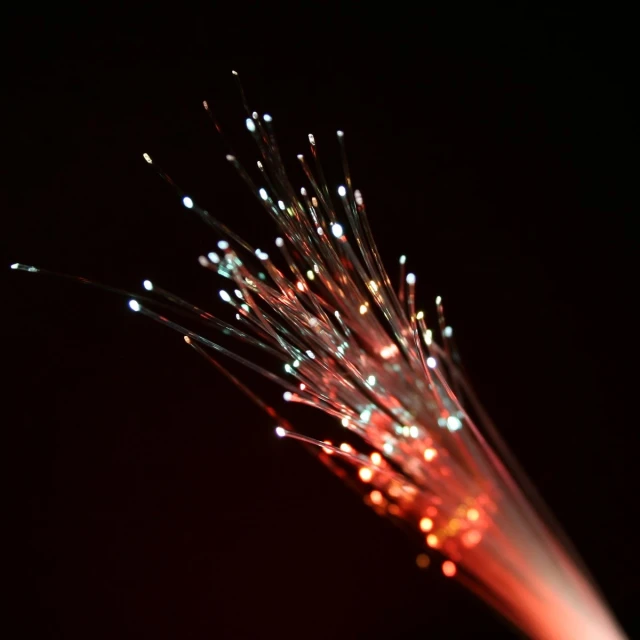 the end of a long fiber is shown with light shining in it