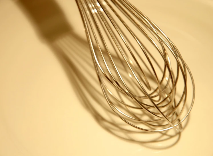 a large metal whisk sitting on top of a counter