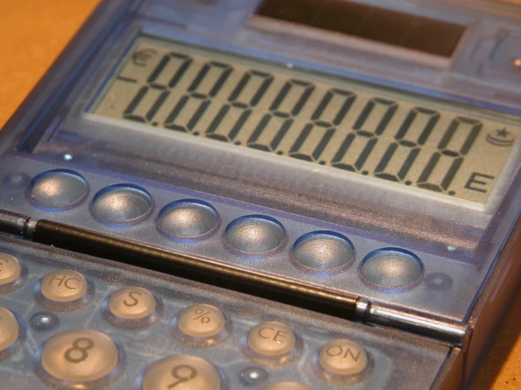 an old fashioned calculator sitting on a table