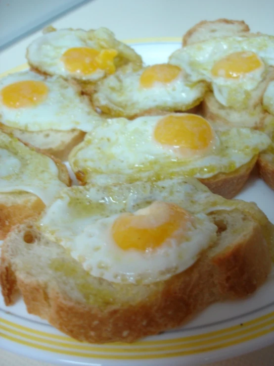 a white plate topped with egg bread slices
